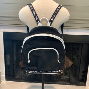 Michael Kors backpack black with white leather accents. Tech ready✅